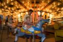 Children and adults ride a carousel at the Iowa state fair in Des Moines.