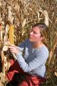 A female farmer looks at feed corn in Canyon County, Idaho. MR