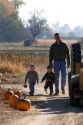 Father and sons at a pumpkin farm in Fruitland, Idaho.