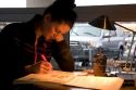 Female college student studying at a coffee shop in Boise, Idaho. MR