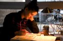 Female college student studying at a coffee shop in Boise, Idaho. MR