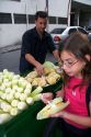 A young girl eating a corn snack she bought from a street vendor in the Liberdade asian section of Sao Paulo, Brazil.