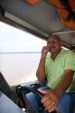 Driver of a river boat on a cell phone near Manaus, Brazil.