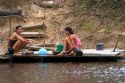 Brazilian girls washing clothes in the Arasa River in the Amazon jungle near Manaus, Brazil.