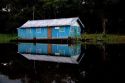 A general store reflected in the Arasa River in the Amazon jungle near Manaus, Brazil.