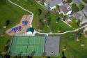 Aerial view of a park with playground equipment, tennis courts and a basketball court in Boise, Idaho.