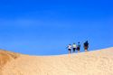 People walking on sand dunes at Pacific City on the Oregon Coast.