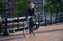 Woman riding a bicycle in Amsterdam, Netherlands.