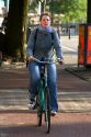 Woman riding a bicycle in Amsterdam, Netherlands.