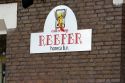 Sign for a coffee shop named Reefer in Amsterdam, Netherlands.