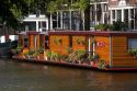 A houseboat docked on the Prinsengracht Canal in Amsterdam, Netherlands.