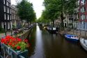 Boats docked on a canal of the Amstel River in Amsterdam, Netherlands.