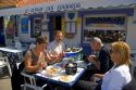 People eating seafood outdoors at a restaurant in the village of Audresselles in the department of Pas-de Calais, France.