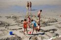 Children dig in the sand on the beach at the village of Wimereux in the department of Pas-de-Calais, France.