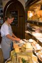 Woman working in a cheese shop in Paris, France.