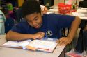 Fourth grade student reading a textbook in a classroom at a public school in Tampa, Florida.