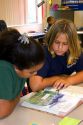 Fourth grade students read a textbook in a classroom at a public school in Tampa, Florida.