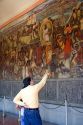 People look at a mural painted by Diego Rivera at the National Palace in Mexico City, Mexico.