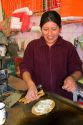 Vendor cooking a gordita at the Merced Market in Mexico City, Mexico.
