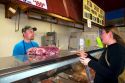 Woman shopping at a butcher shop in Boise, Idaho. MR