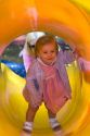 15 month old girl inside a covered slide at a park in Tampa, Florida. MR