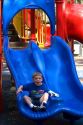 3 year old boy playing on playground equipment at a park in Tampa, Florida. MR