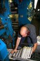 Pressman pulling newspapers from the rotary printing press for the Houston Chronicle in Houston, Texas.
