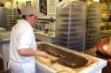 Worker making chocolate fudge at a candy shop in Sault Ste. Marie, Michigan.