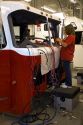 Female worker installing wiring into a newly manufactured fire truck chassis at Spartan Motors in Charlotte, Michigan.