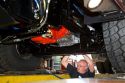 Worker looks under a newly manufactured fire truck chassis at Spartan Motors in Charlotte, Michigan.