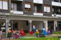 Children use playground equipment in front of an apartment housing unit in Guernica in the province of Biscay, Basque Country, Northern Spain.