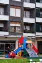 Children use playground equipment in front of an apartment housing unit in Guernica in the province of Biscay, Basque Country, Northern Spain.