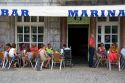 People dine outdoors at a bar located in the town of Lekeitio in the Province of Biscay, Basque Country, Northern Spain.