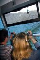 Passengers riding in an aerial tramway take photographs of the Pico de Europa mountains at Fuente De, Liebana, Cantabria, northwestern Spain.