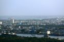 Cityscape view of a smoggy Ho Chi Minh City and Saigon River from atop the Saigon Trade Center skyscraper, Vietnam.