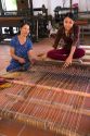 Vietnamese women weaving mats at a craft factory in Hoi An, Vietnam.