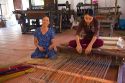 Vietnamese women weaving mats at a craft factory in Hoi An, Vietnam.