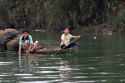 Vietnamese people transporting fishing nets by boat on the Perfume River at Hue, Vietnam.