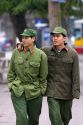 Vietnamese soldiers walk close together as a cultural jesture in Hanoi, Vietnam.