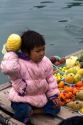 Vietnamese child on a boat selling fruit in Ha Long Bay, Vietnam.