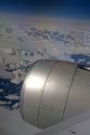 Aerial view of the glaciers and icebergs of Greenland from the window of an Airbus 330 passenger jet airliner.