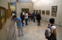 Visitors view artwork displayed in the Musee d'Orsay, Paris, France.