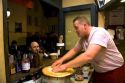 French man making crepes at a Creperie in the Montmartre District of Paris, France.