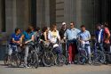 Tourists on bicycles in front of the Louvre Palace housing the Louvre Museum in Paris, France.
