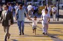 Parents hold their childs hand while crossing the street in Santiago, Chile.