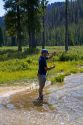 Fisherman catching a trout at Bull Trout Lake located in the Boise National Forest near Lowman, Idaho, USA.