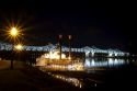 Steamboat docked at night near the Natchez-Vidalia Bridges spanning the Mississippi River between Vidalia, Louisiana and Natchez, Mississippi, USA.