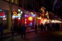Neon signs of bars and restaurants along Bourbon Street in the French Quarter of New Orleans, Louisiana, USA.