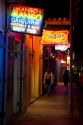 Neon signs of bars and restaurants along Bourbon Street in the French Quarter of New Orleans, Louisiana, USA.