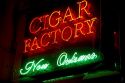 Cigar Factory neon sign in the French Quarter of New Orleans, Louisiana, USA.